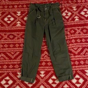 Green flared mom jeans with cuffed ankle.